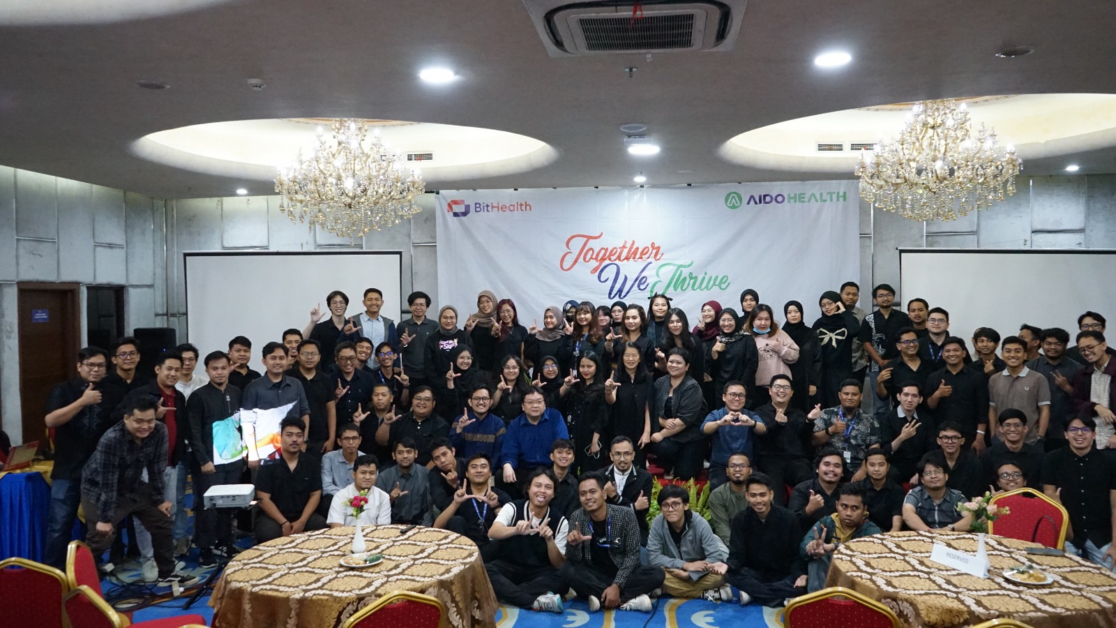 Man pinning images on wall